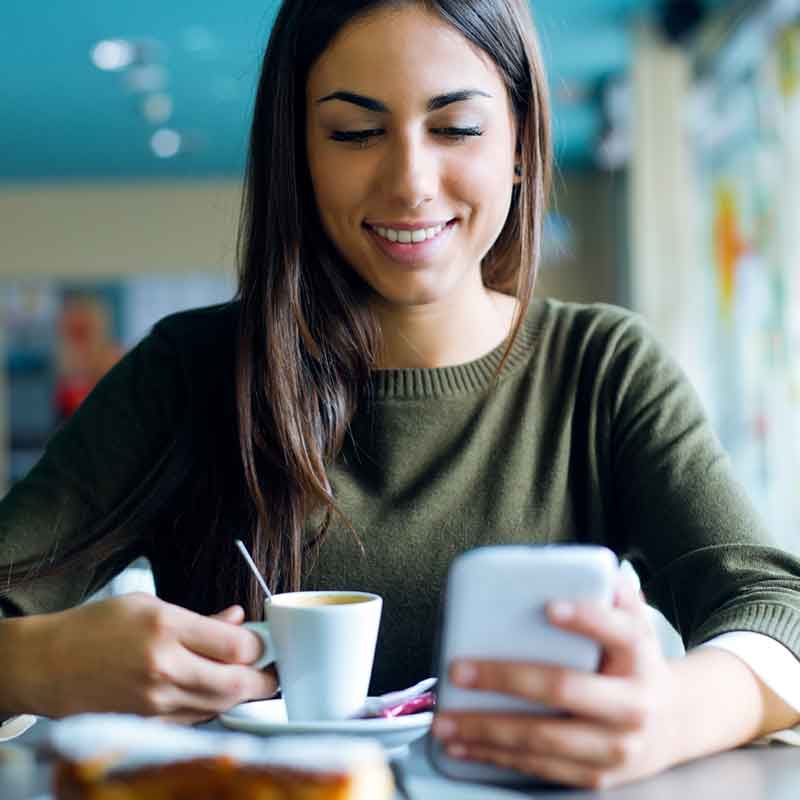 pencil-and-coffee-beautiful-girl-using-her-mobile-phone-in-cafe